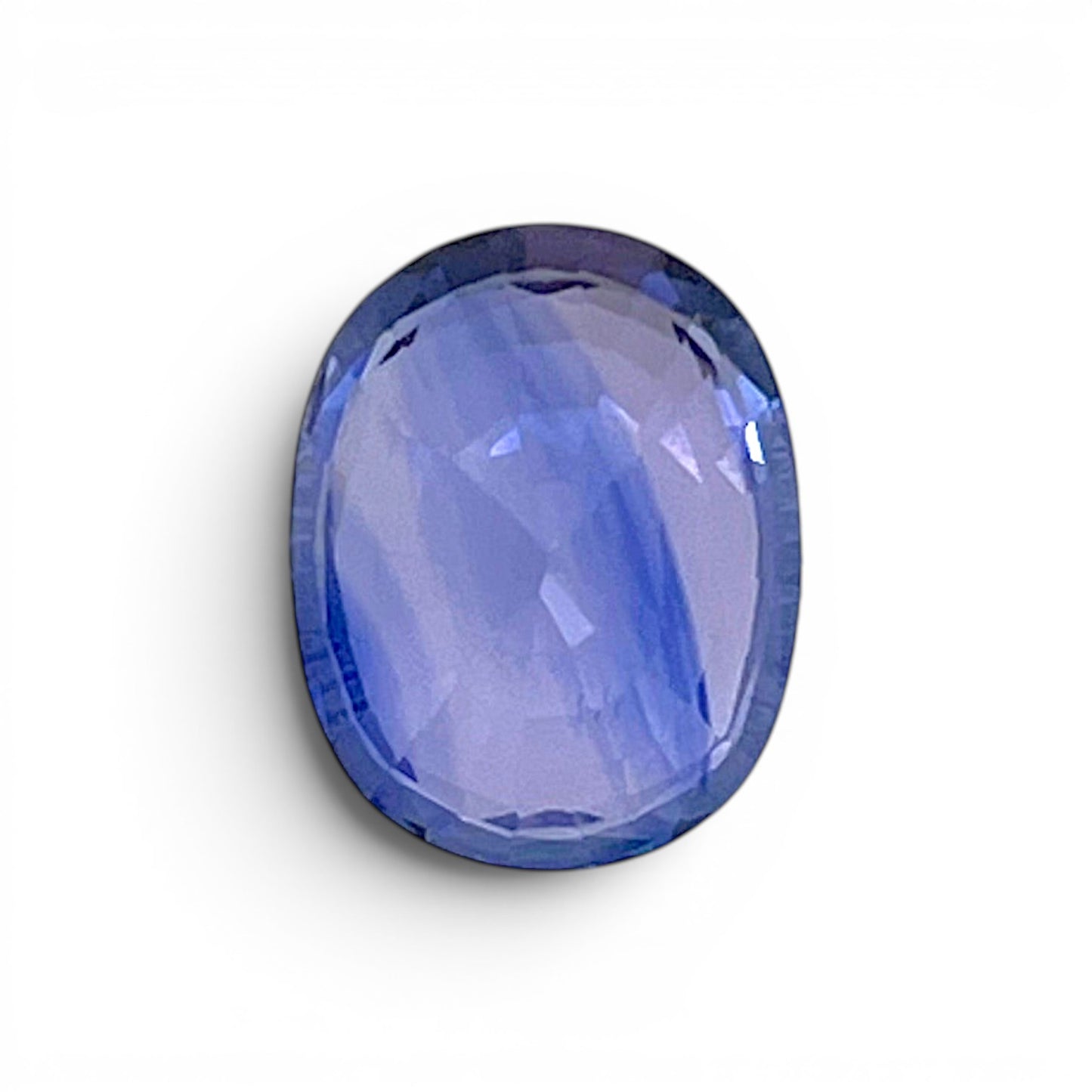Reverse back view of the natural oval cushion-shaped blue sapphire from Ceylon demonstrating its exceptional clarity, clean facets, and fine luster.