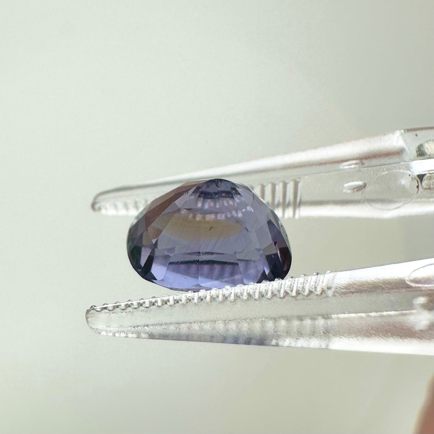 Side profile view of the unheated 2.70 carat Vietnam lavender spinel highlighting its perfect symmetry and pavilion depth.