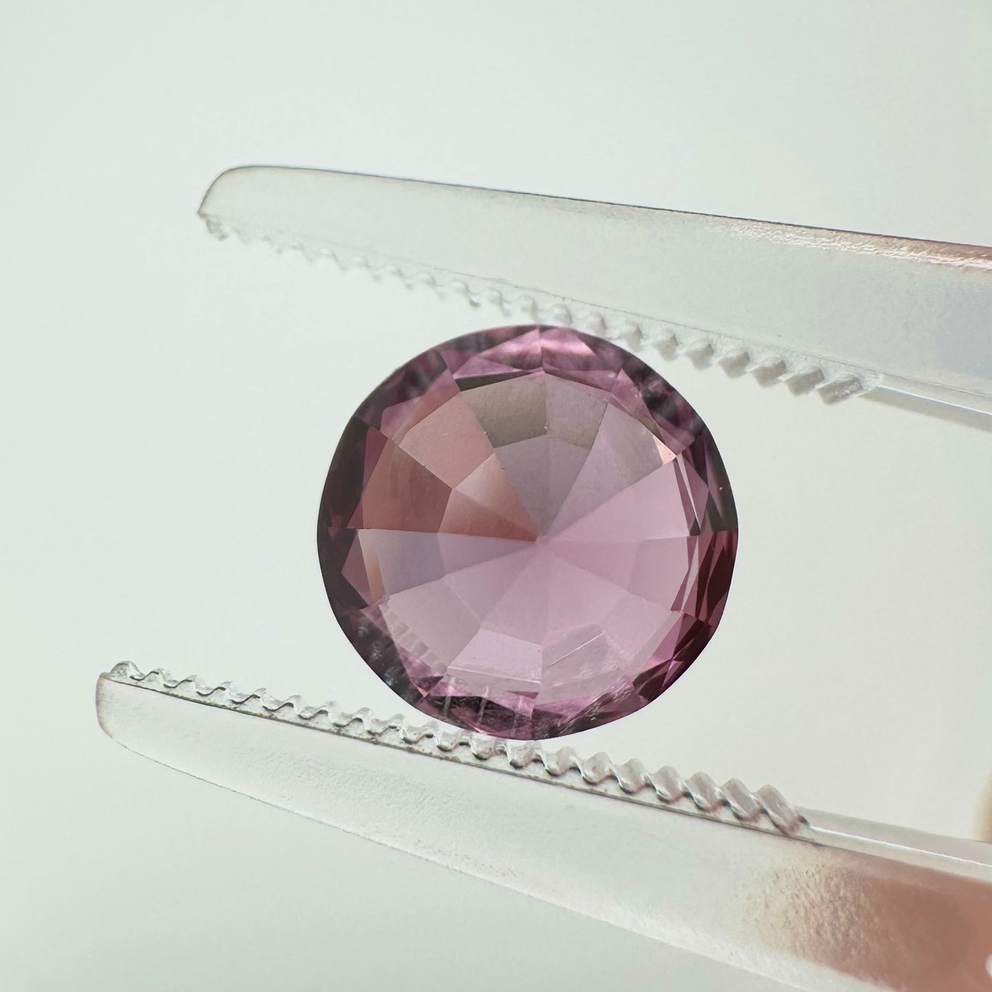 Reverse back view of the natural round cut vivid pink spinel from Vietnam demonstrating its excellent clarity and lack of treatment.