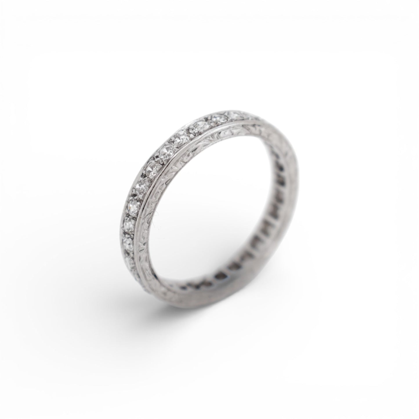 Close-up of the delicate hand-engraved milgrain edge on an Art Deco eternity ring