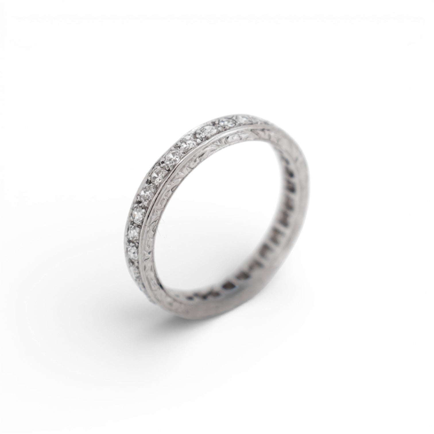 Close-up of the delicate hand-engraved milgrain edge on an Art Deco eternity ring