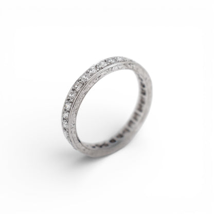Close-up of the delicate hand-engraved milgrain edge on an Art Deco eternity ring