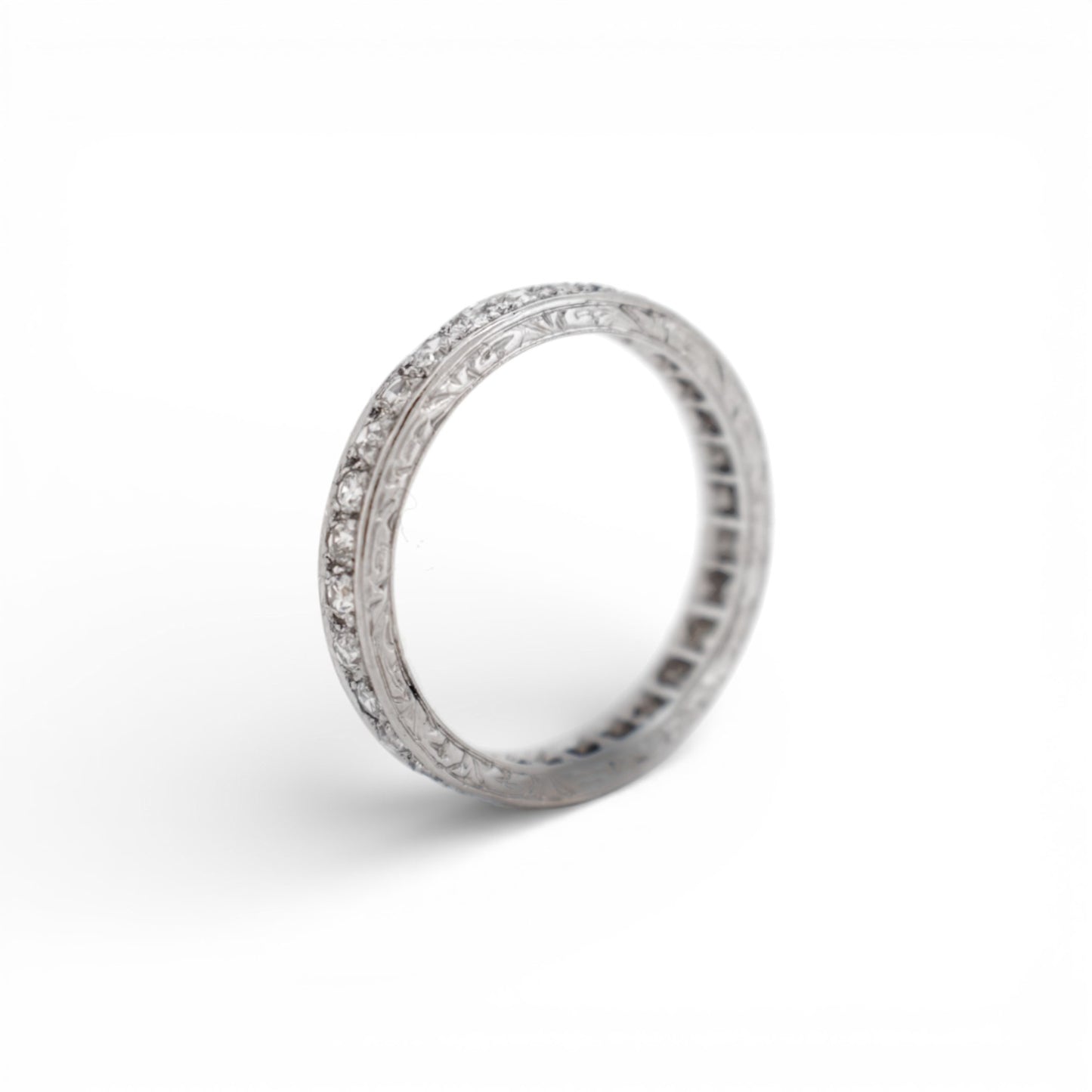 Detailed macro shot of D/E/F color colorless diamonds on an antique platinum band