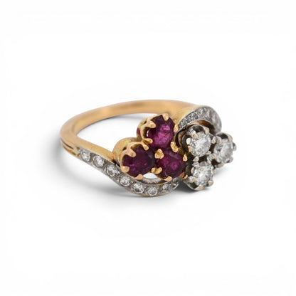 Side angle of 11.5mm wide antique ruby and diamond clover ring showing the stylized stem band