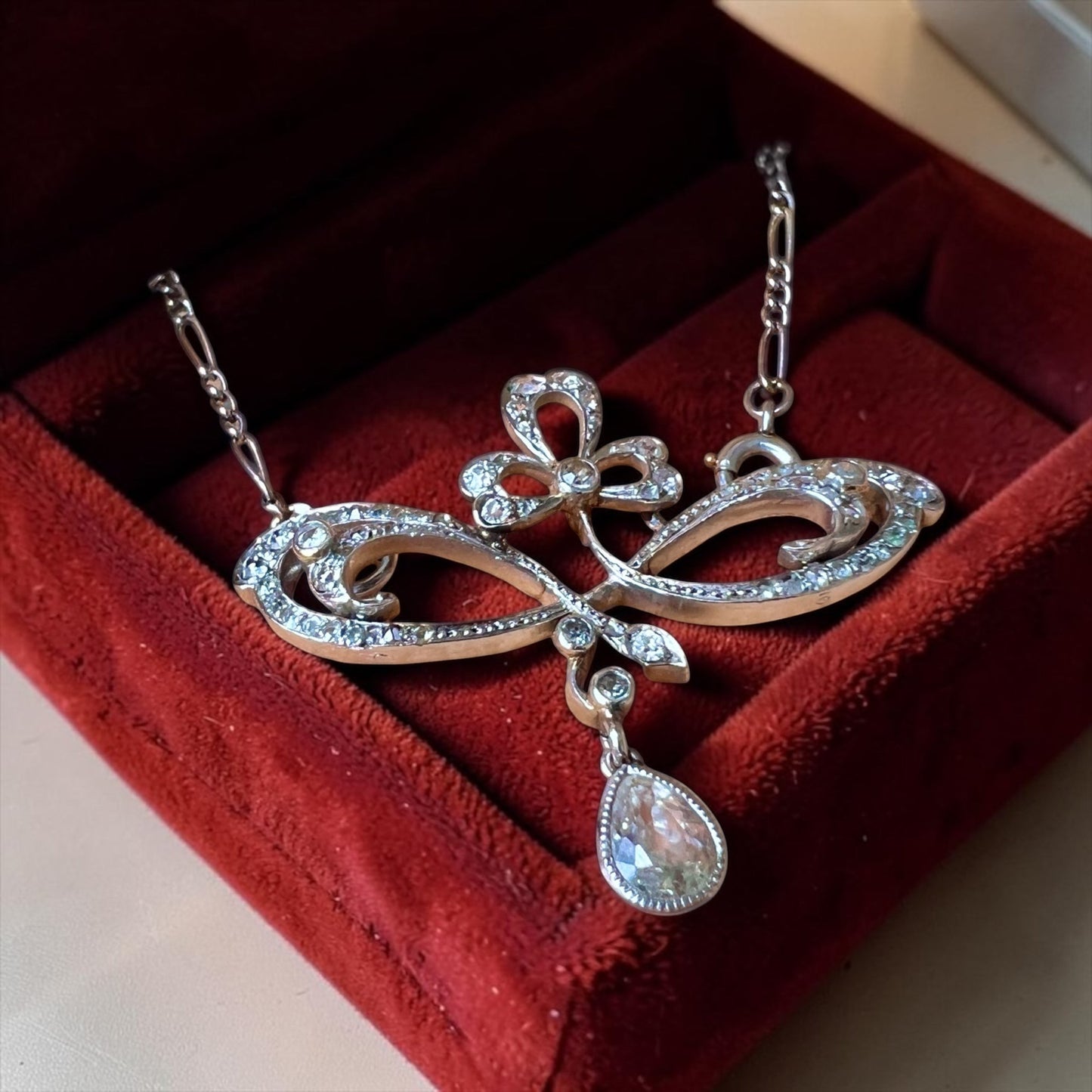 Detailed view of old cut and rose cut diamonds set in stylized platinum scrolls