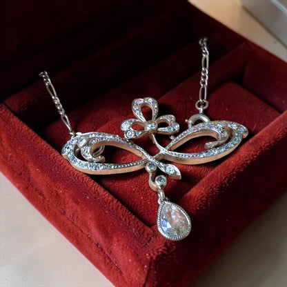 Detailed view of old cut and rose cut diamonds set in stylized platinum scrolls