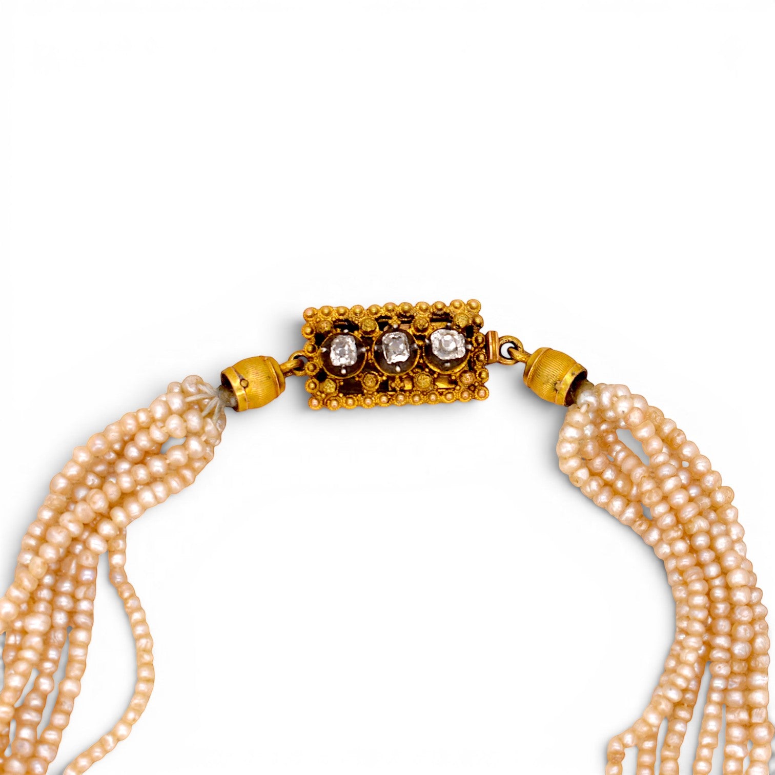 Detailed macro view of the 18k gold push-button clasp set with three natural old-cut diamonds totaling 0.30ctw.