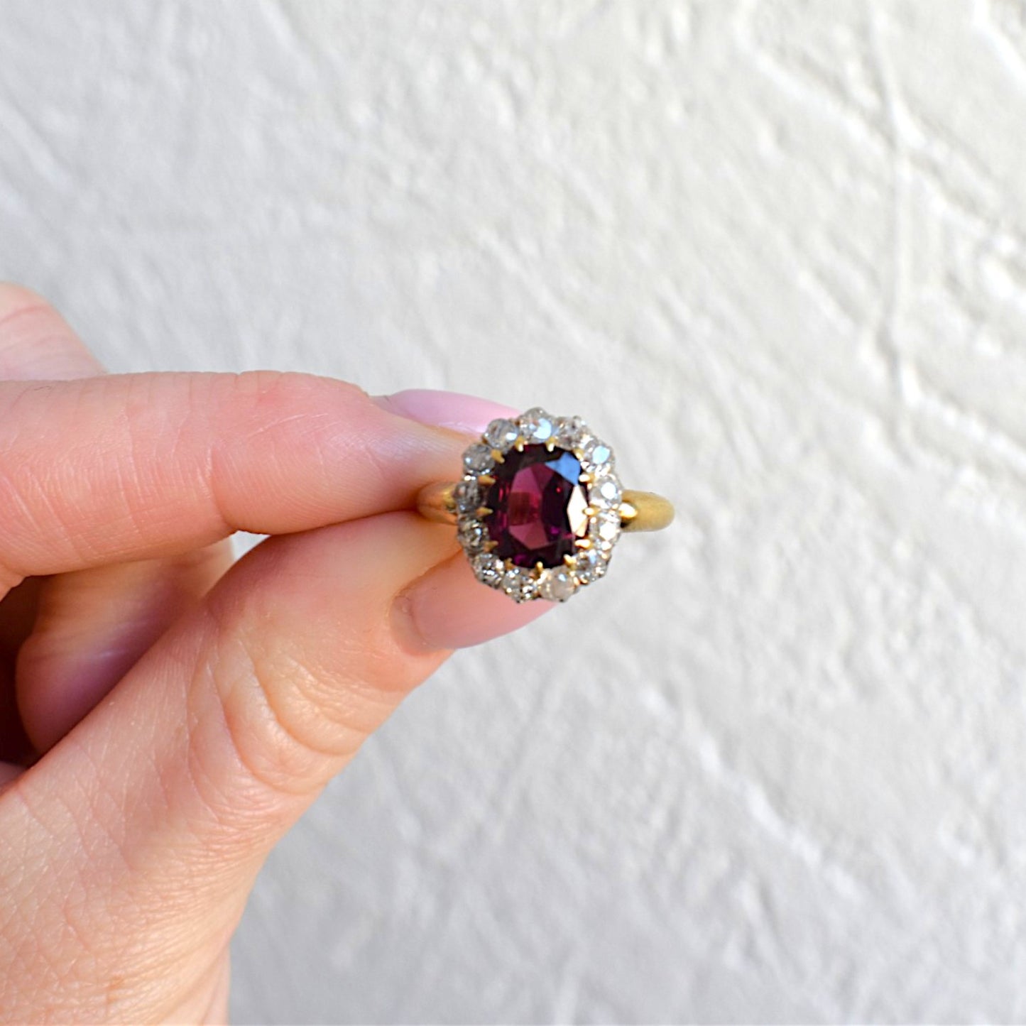Close-up of vibrant raspberry red rubellite garnet in a 19th-century gold setting