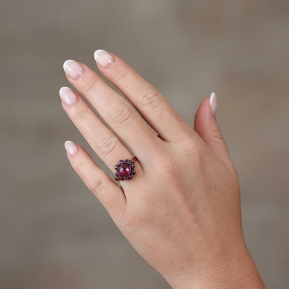 vintage ring gold and garnet, worn on a feminine hand