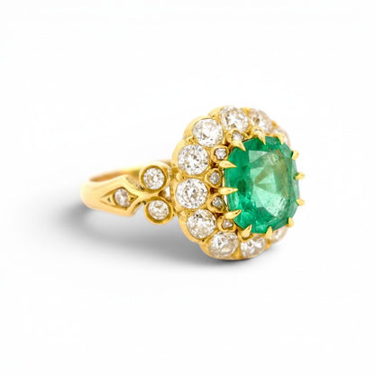 Detailed macro view of the two-tier crown setting featuring antique rose-cut diamonds surrounding the central Zambian emerald.