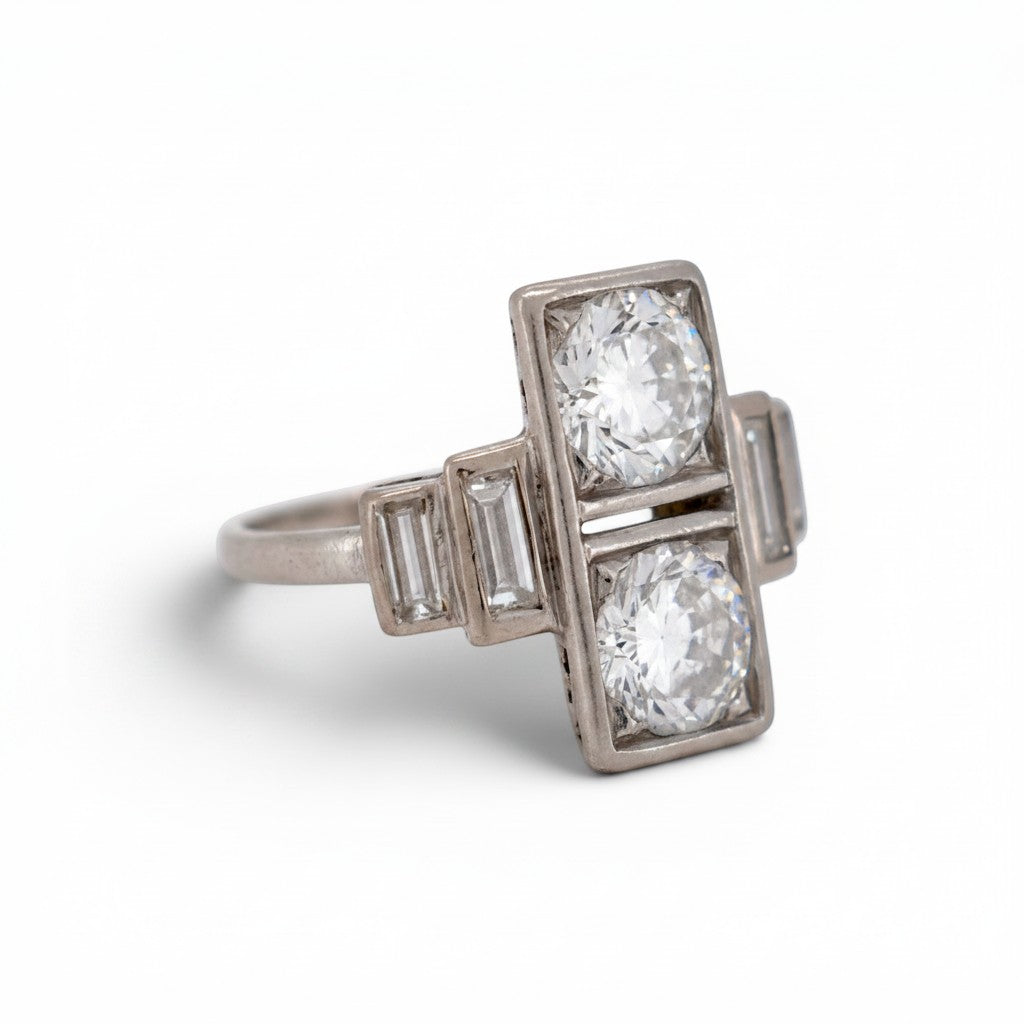 Detailed macro shot of the twin old European cut diamonds displaying exceptional F/G color and hand-faceted fire.