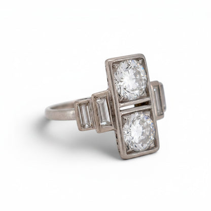 Detailed macro shot of the twin old European cut diamonds displaying exceptional F/G color and hand-faceted fire.