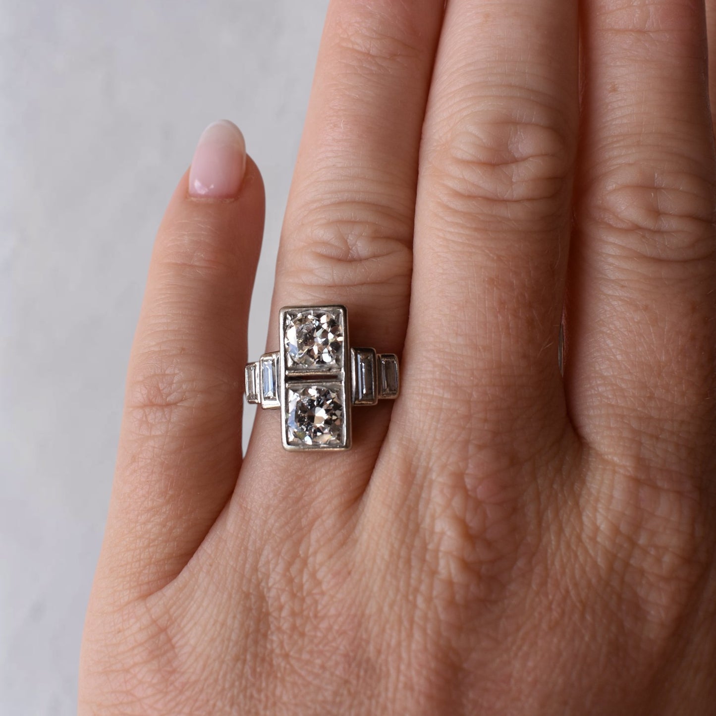 Extreme close-up shot of the hand wearing the 15mm wide old-cut diamond ring, showcasing its scale, finger coverage, and sparkle.