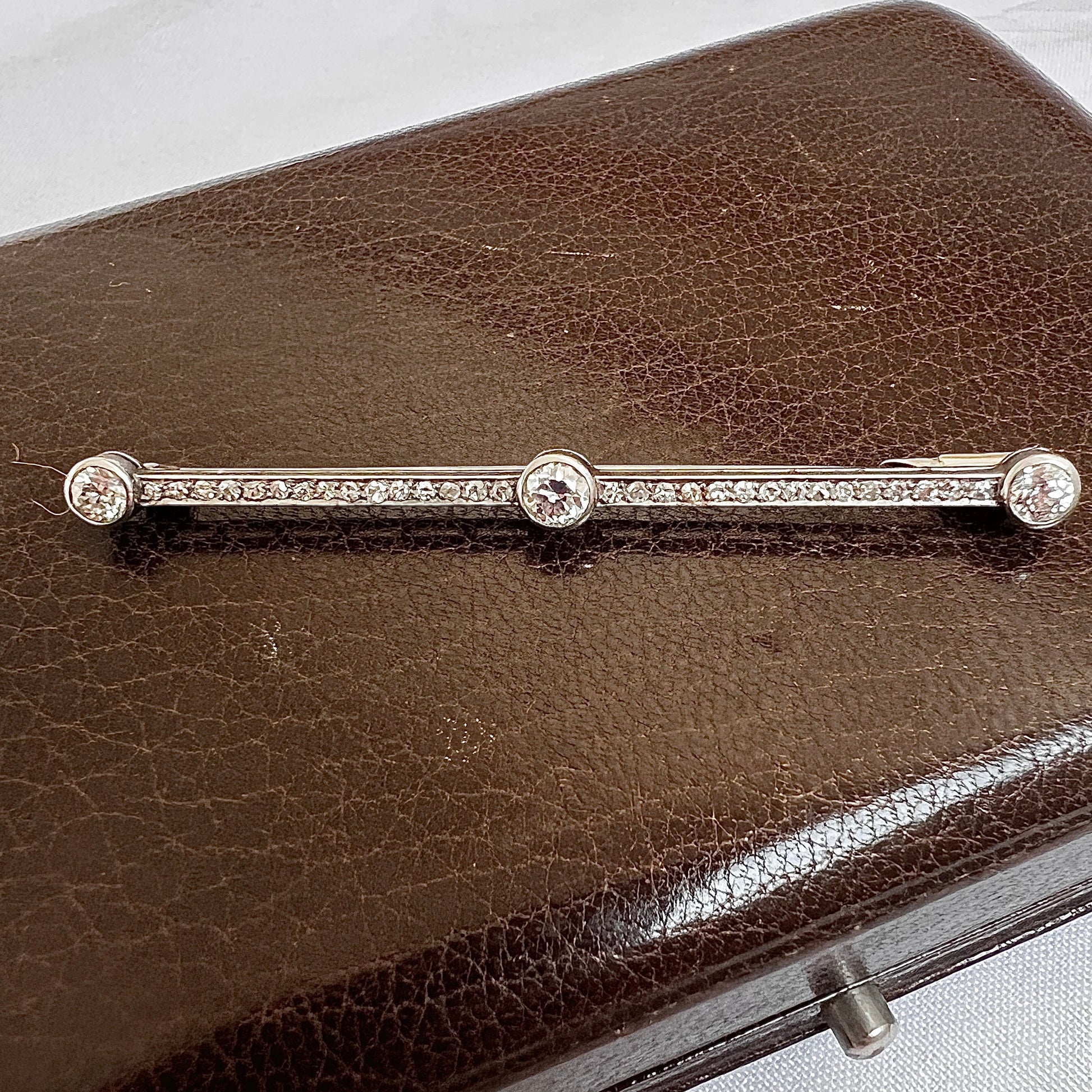 Trio of Old European cut diamonds on a 62mm antique platinum bar brooch