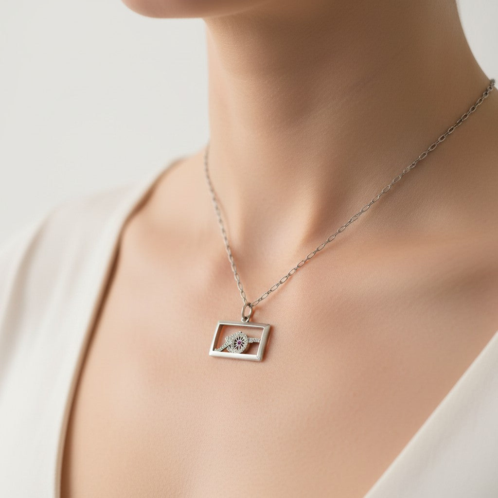 Antique Art Deco platinum military cannon pendant worn elegantly as a daily necklace on a fine white gold chain.