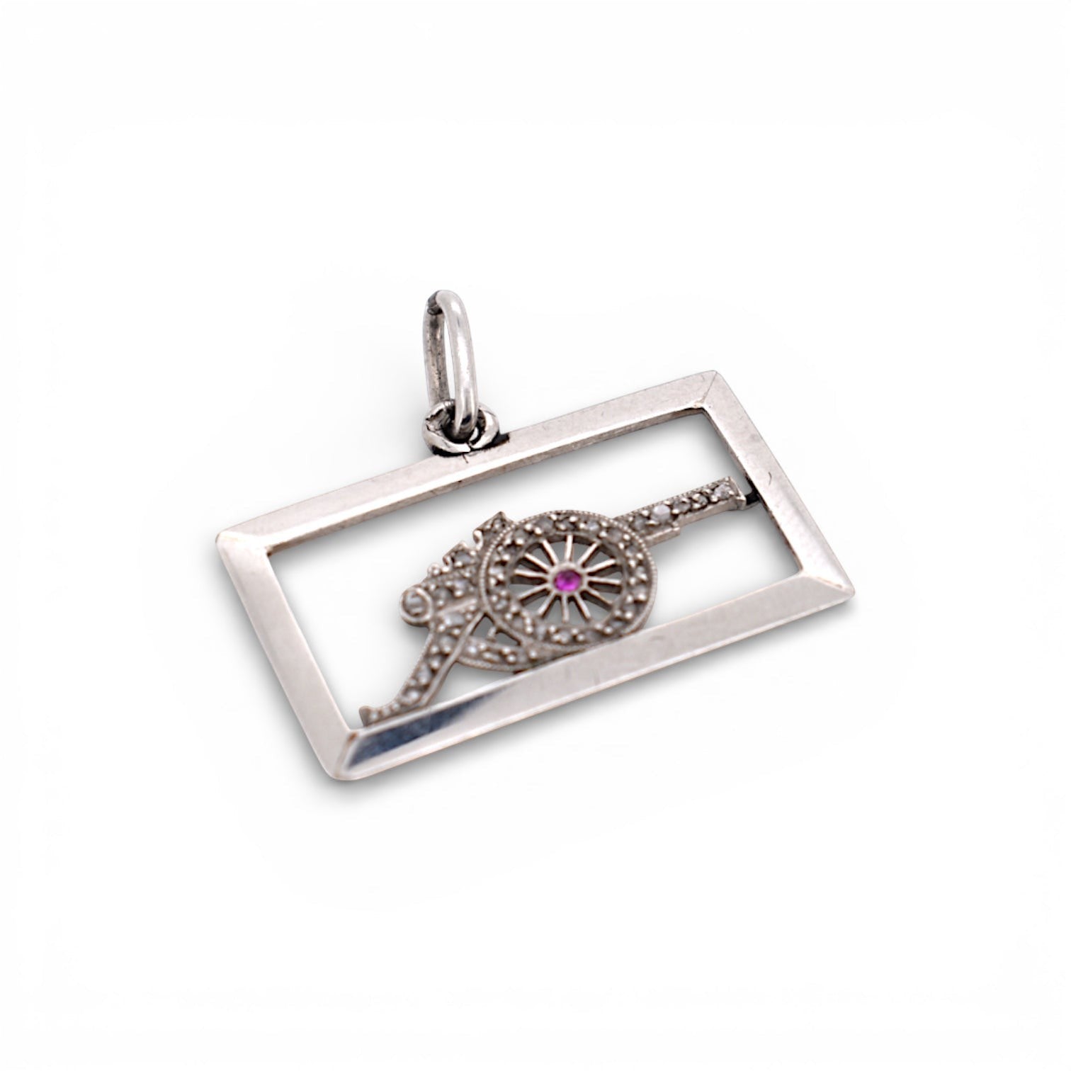 Detailed macro view of the platinum openwork cannon showing the fine diamond pavé and the central red ruby.