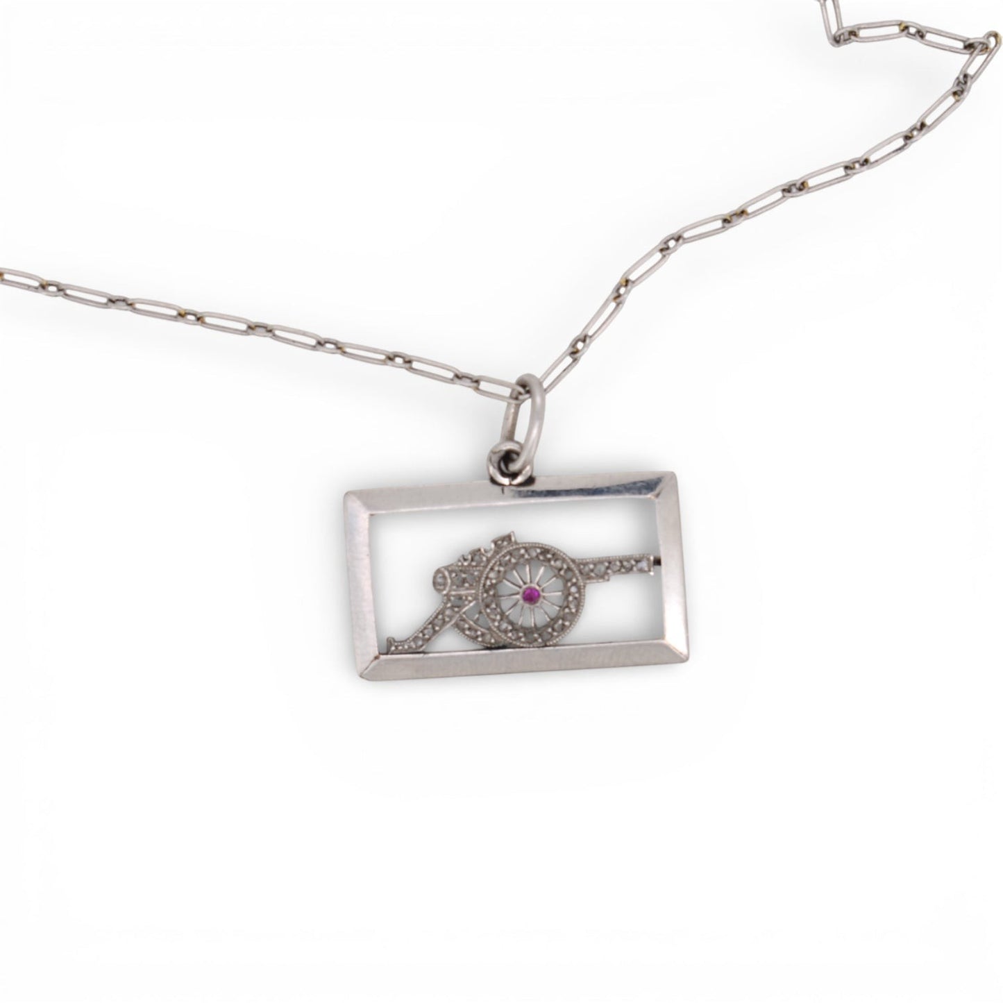 Antique platinum diamond cannon charm displayed beautifully on a chain inside.