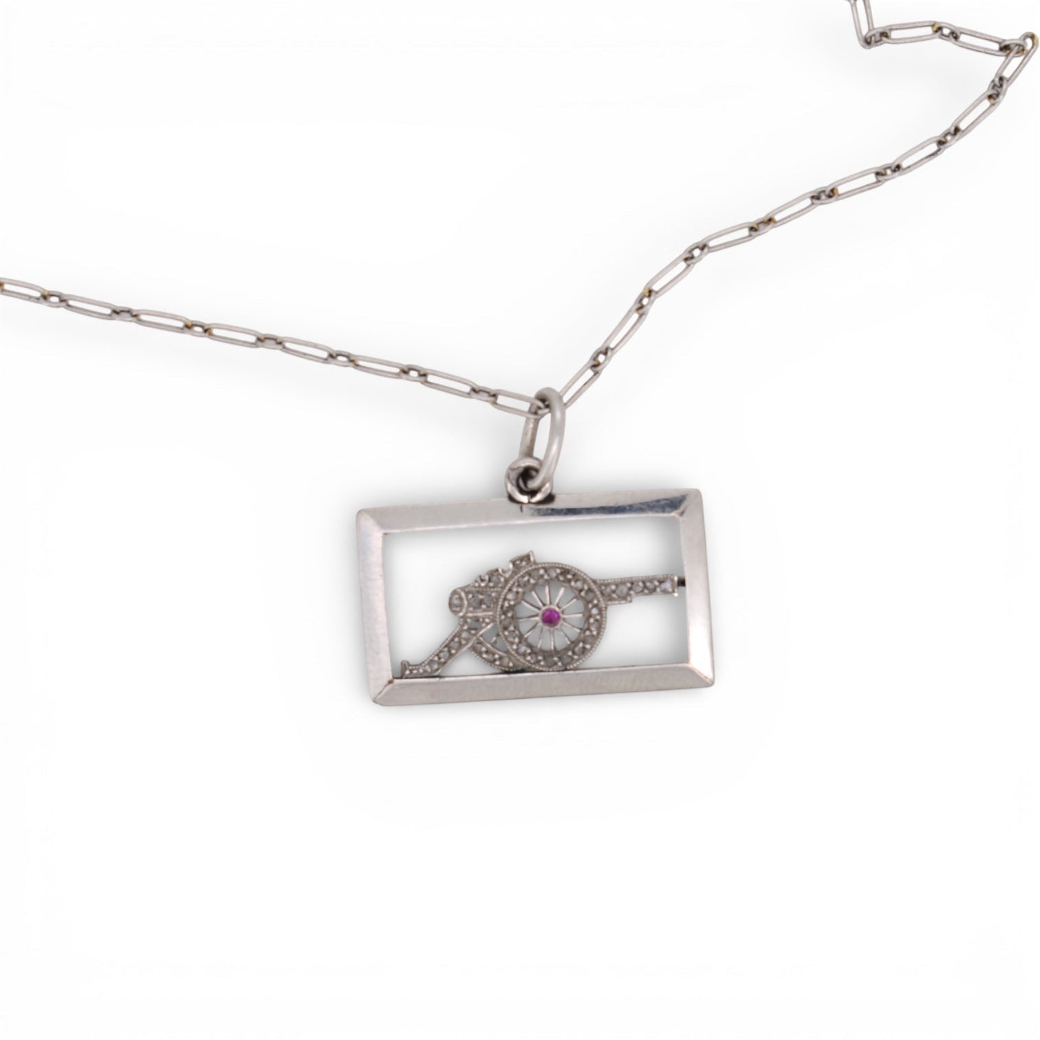 Antique platinum diamond cannon charm displayed beautifully on a chain inside.