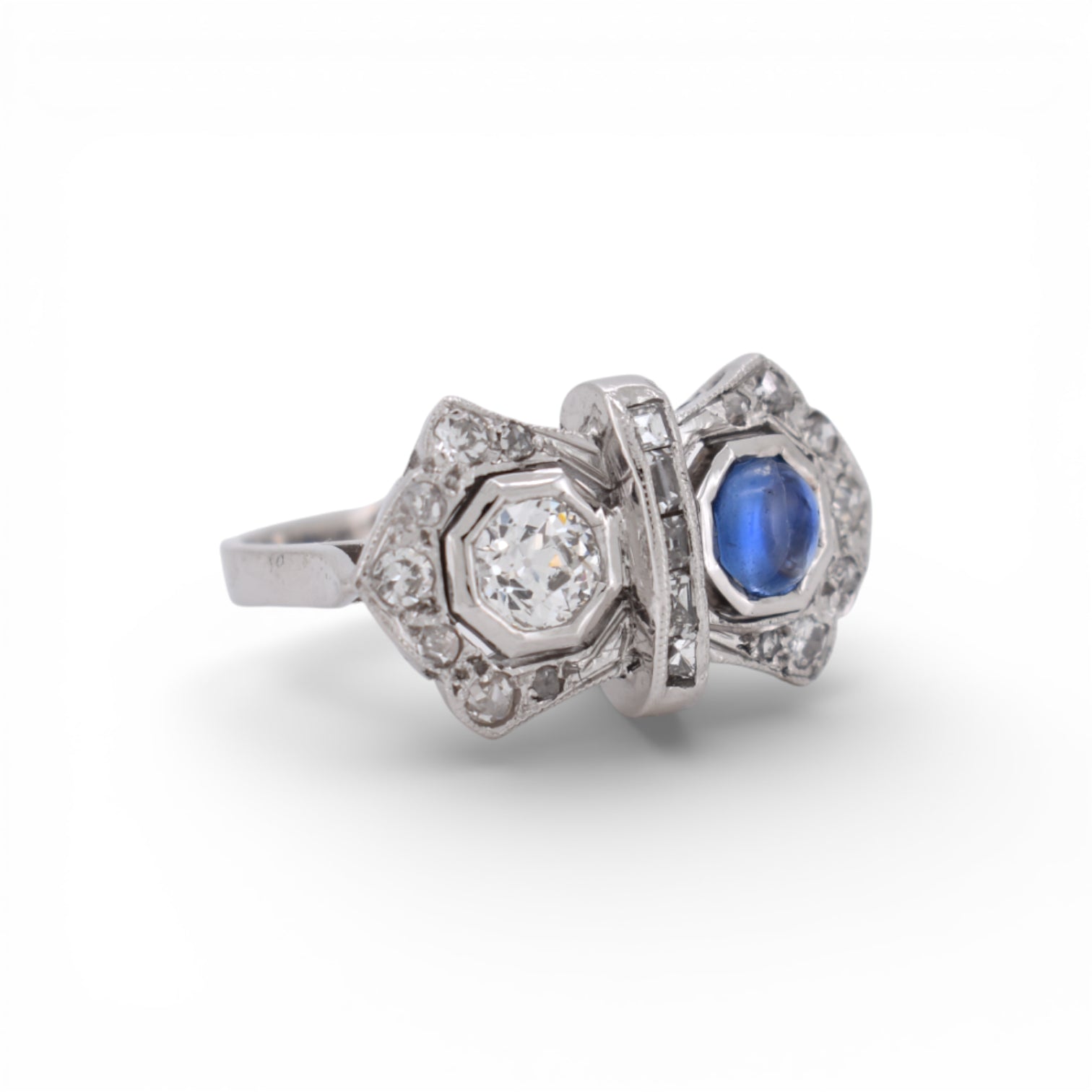 Side profile view of the intricate 18K white gold setting on a 1920s Toi et Moi ring.