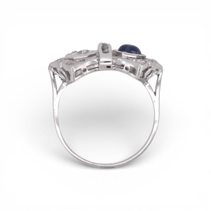 Angled view highlighting the geometric Art Deco design of a sapphire and diamond double-stone ring.