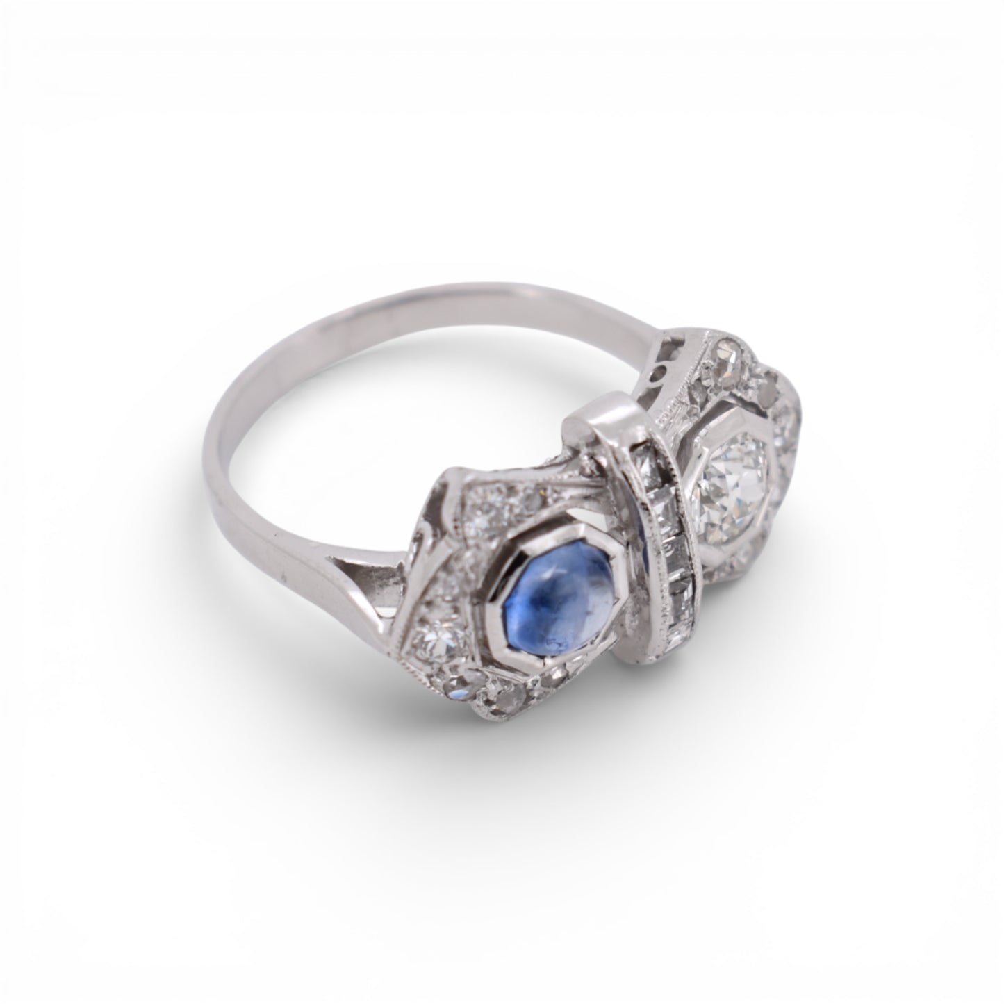 An other angled view highlighting the geometric Art Deco design of a sapphire and diamond double-stone ring.