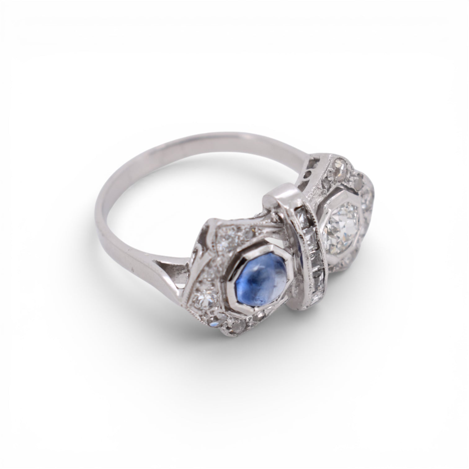 An other angled view highlighting the geometric Art Deco design of a sapphire and diamond double-stone ring.