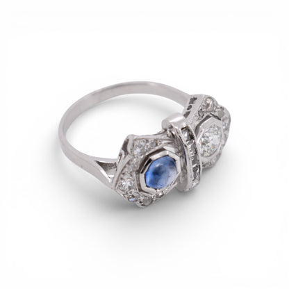An other angled view highlighting the geometric Art Deco design of a sapphire and diamond double-stone ring.