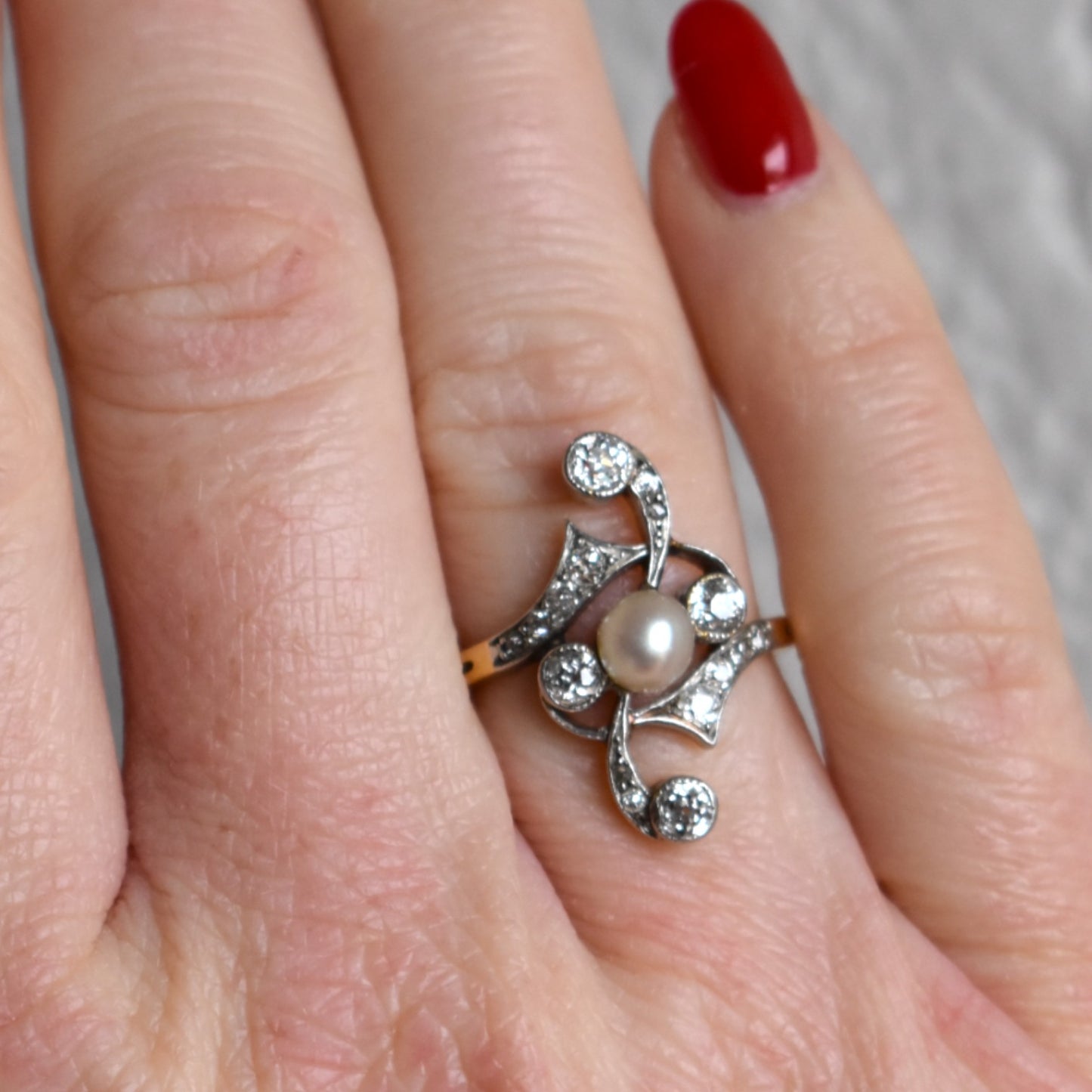 Detailed view of a 5.3mm lustrous pearl on an antique Art Nouveau gold ring