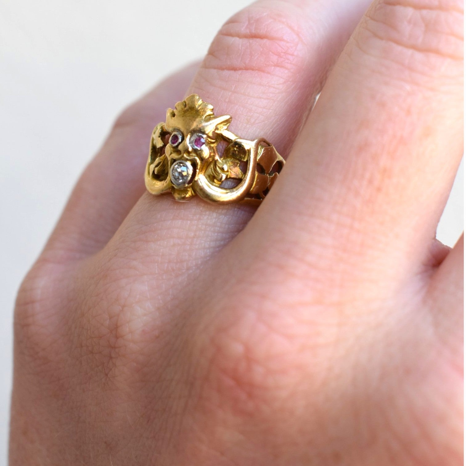 Side shot of an antique Art Nouveau chimera ring worn on hand 18k gold 