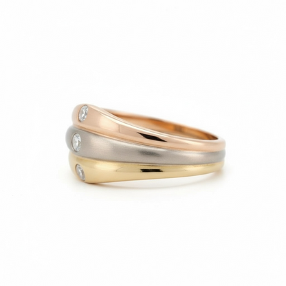 Close-up of yellow, white, and rose gold bands on a Cartier diamond ring