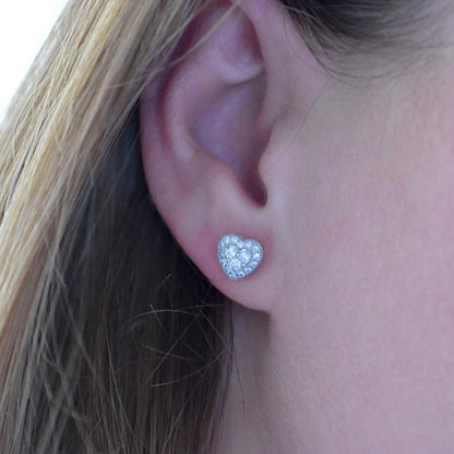 Chopard inspired diamond heart earrings worn on an ear for scale and sparkle