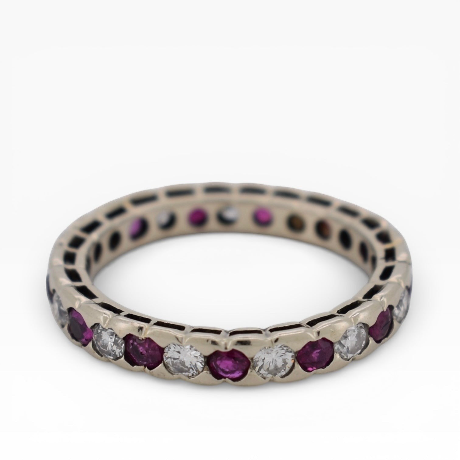 Top-down view showing the continuous gemstone loop of a full ruby diamond eternity band