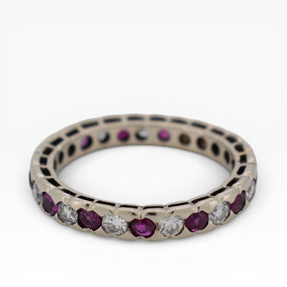 Top-down view showing the continuous gemstone loop of a full ruby diamond eternity band