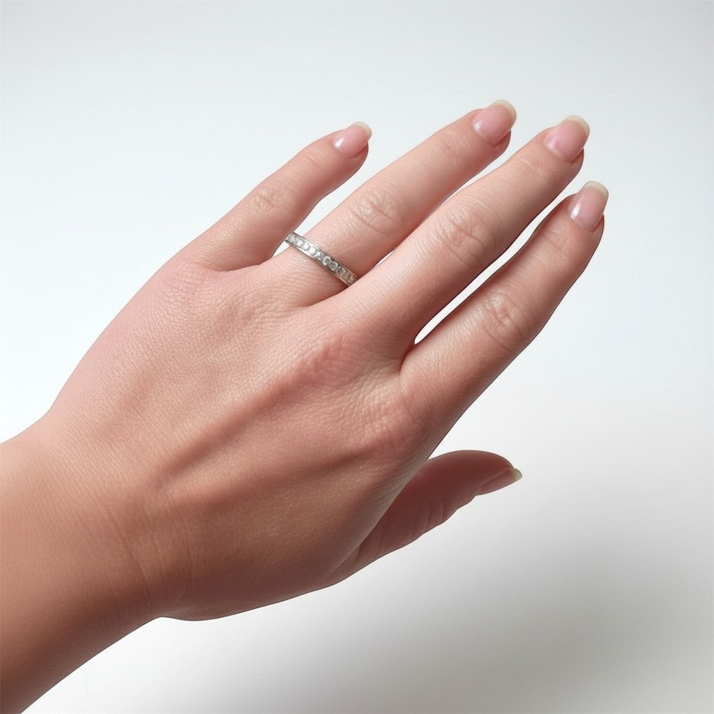 Lifestyle view of a hand wearing a 3mm wide antique diamond eternity ring, showing the unbroken stream of diamonds around the finger.