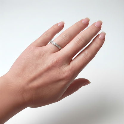 Lifestyle view of a hand wearing a 3mm wide antique diamond eternity ring, showing the unbroken stream of diamonds around the finger.