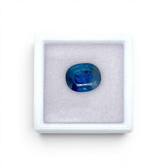 Loose 3.62 carat natural oval cushion cut blue sapphire gemstone displayed inside a luxury presentation gem box by Antique Jewelry Finds.