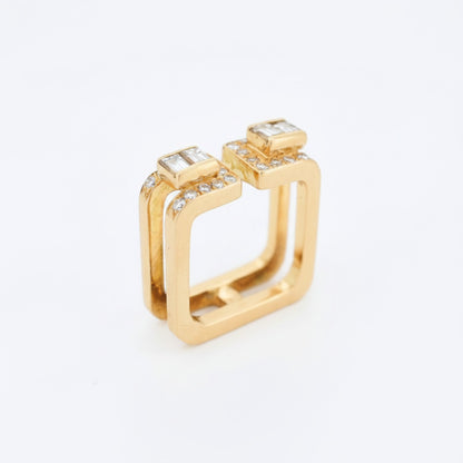 Close-up of brilliant and baguette cut diamonds on square Jean Vendôme modernist gold ring