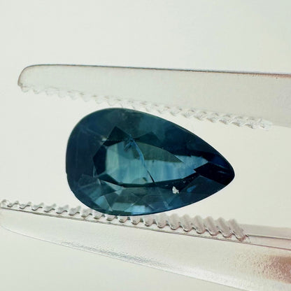 Extreme macro face shot of the 1.40ct natural blue sapphire showcasing its elegant pear shape, brilliant teardrop proportions, and rich color.