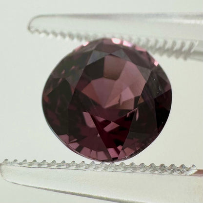 Extreme macro face shot of the 3.20ct natural deep pink spinel showcasing its exceptional oval cushion cut and crisp facets.