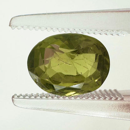 Extreme macro face shot of the 2.47ct natural green Ceylon sapphire showcasing its elegant oval cut and crisp, brilliant facets.