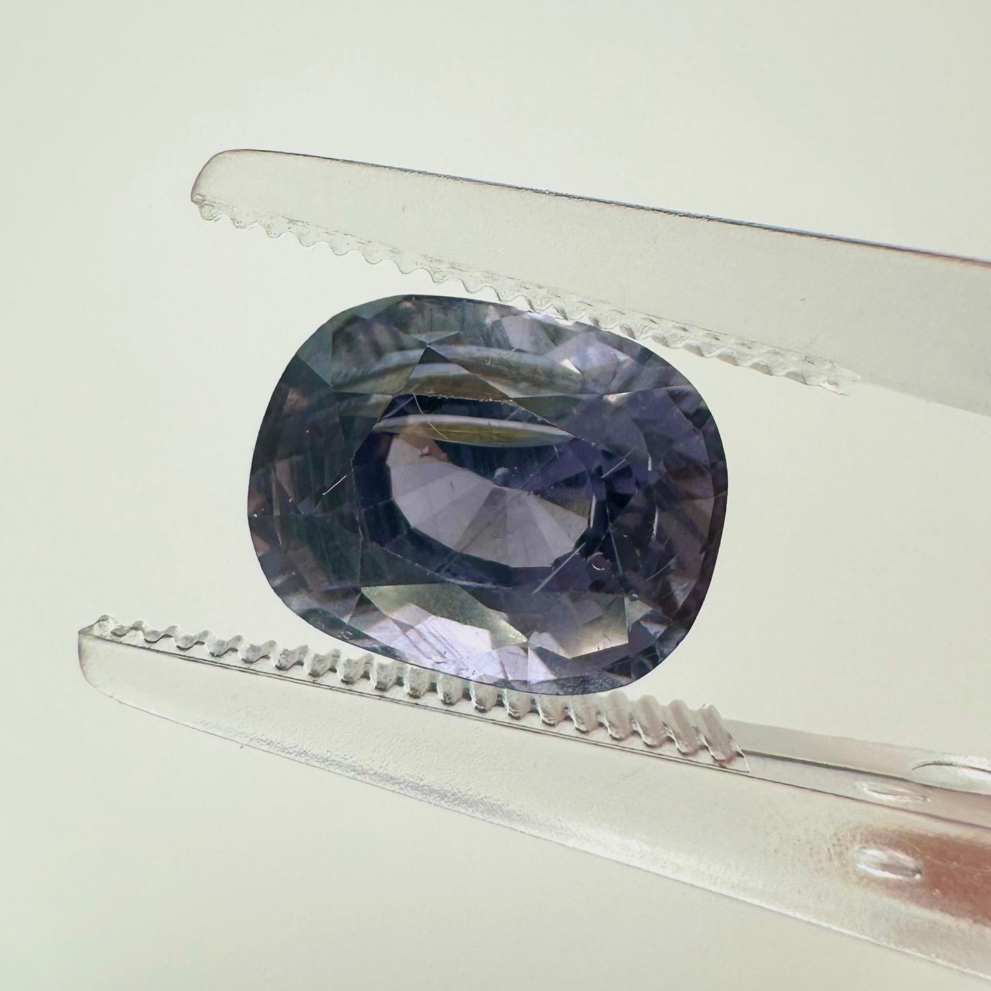 Extreme macro face shot of the 2.70ct natural lavender purple spinel showcasing its exceptional oval cushion cut and crisp facets.