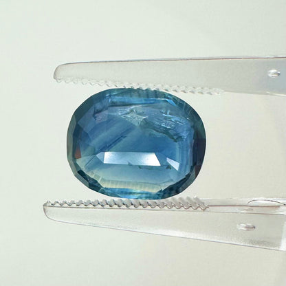 Reverse back view of the natural oval cushion-shaped blue sapphire demonstrating its beautiful clarity, clean facets, and fine luster.
