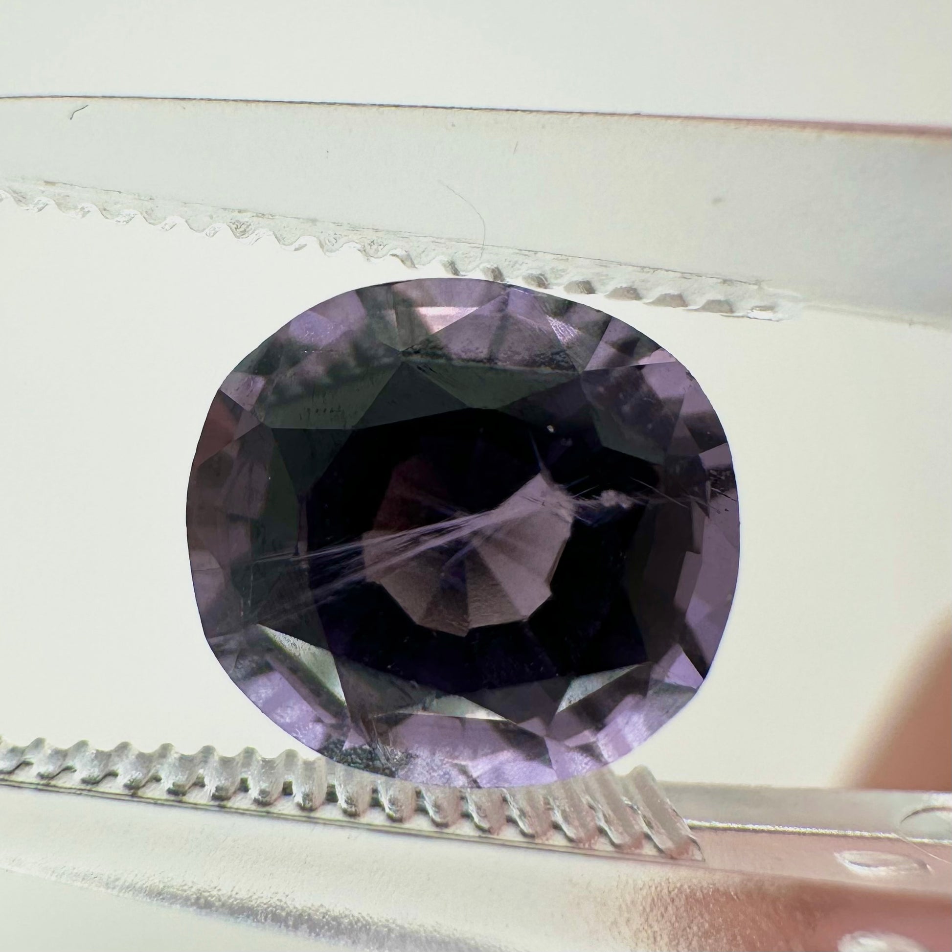 Extreme close-up shot of the 2.10ct unheated Vietnam purple spinel showcasing its crisp cushion facets and natural clarity.