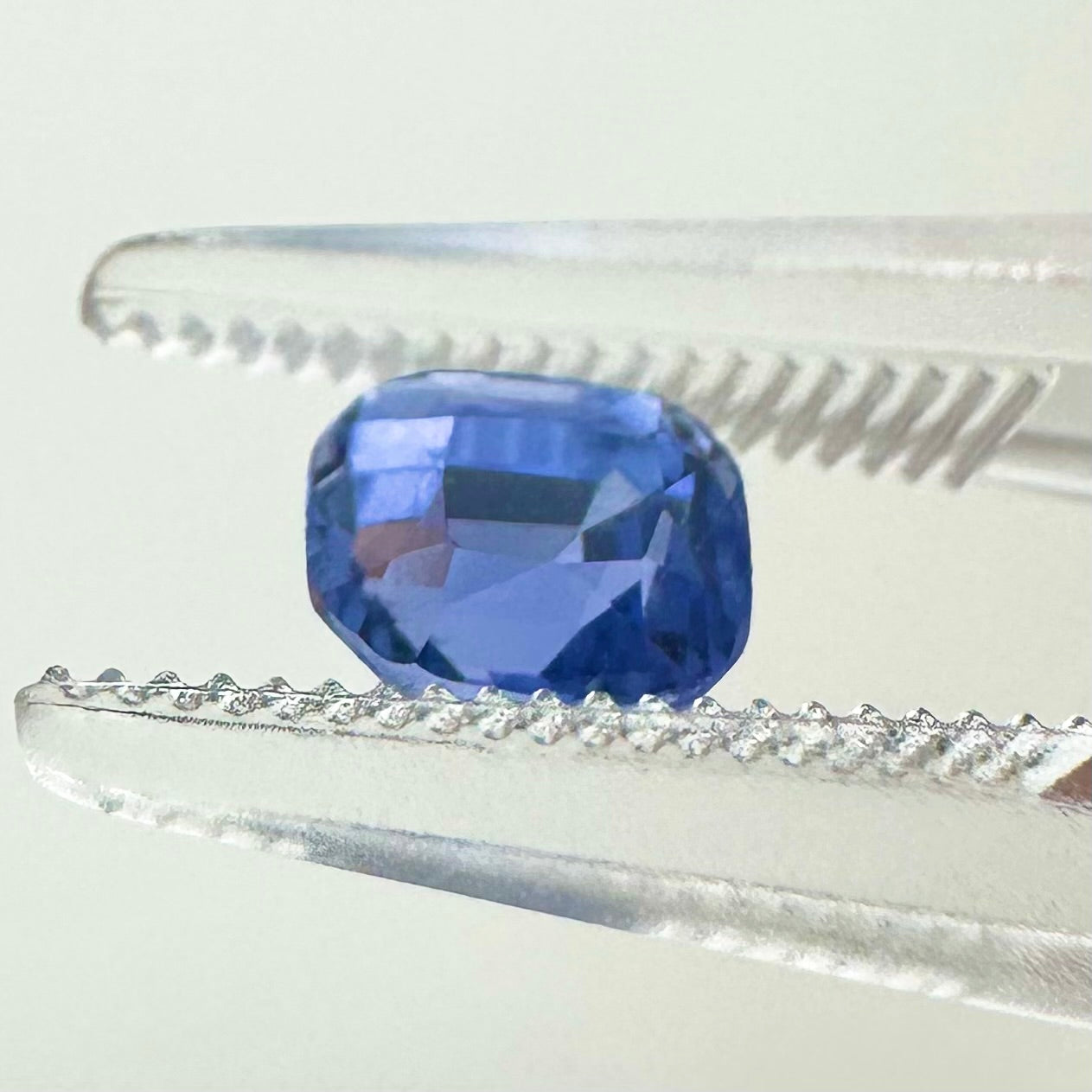 Side profile view of the unheated 0.89 carat Sri Lankan emerald cut sapphire highlighting its perfect symmetry and pavilion depth.