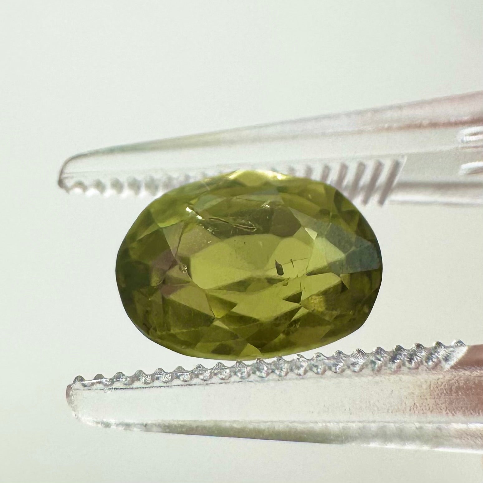 Side profile view of the unheated 2.47 carat Sri Lankan green sapphire highlighting its perfect symmetry and pavilion depth.