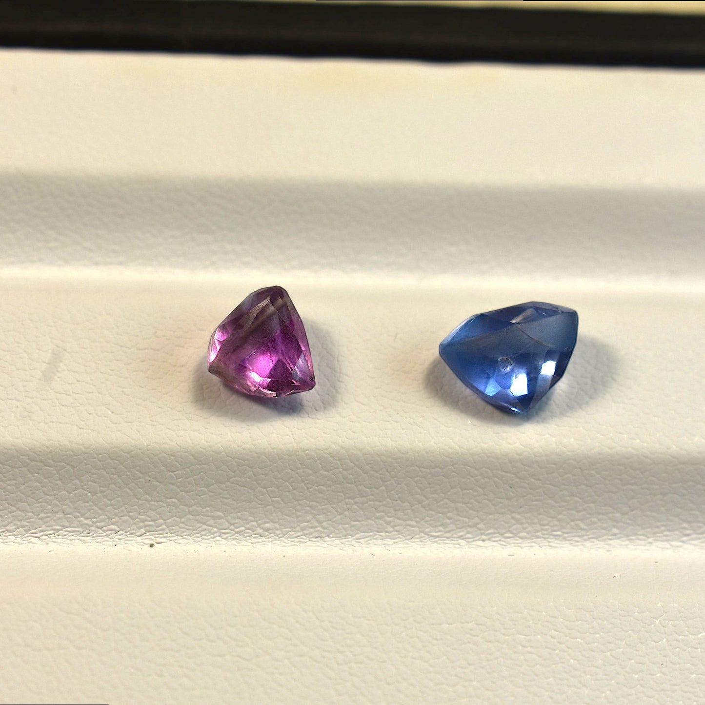 Side profile view of the unheated 5 carats total Sri Lankan old cut sapphires highlighting their authentic antique proportions and unique pavilion depths.