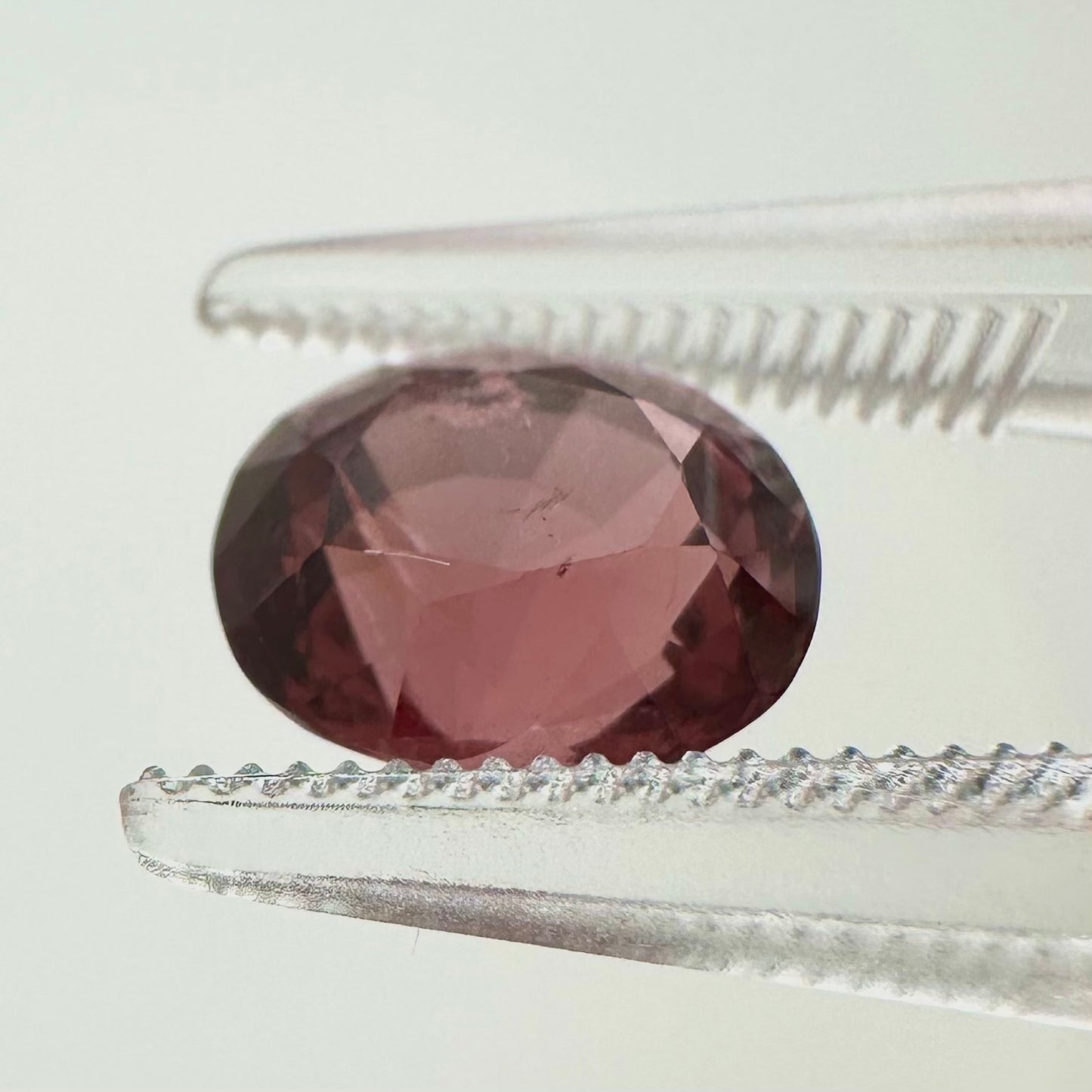 Side profile view of the unheated 2.30 carat Vietnam deep pink spinel highlighting its perfect symmetry and pavilion depth.