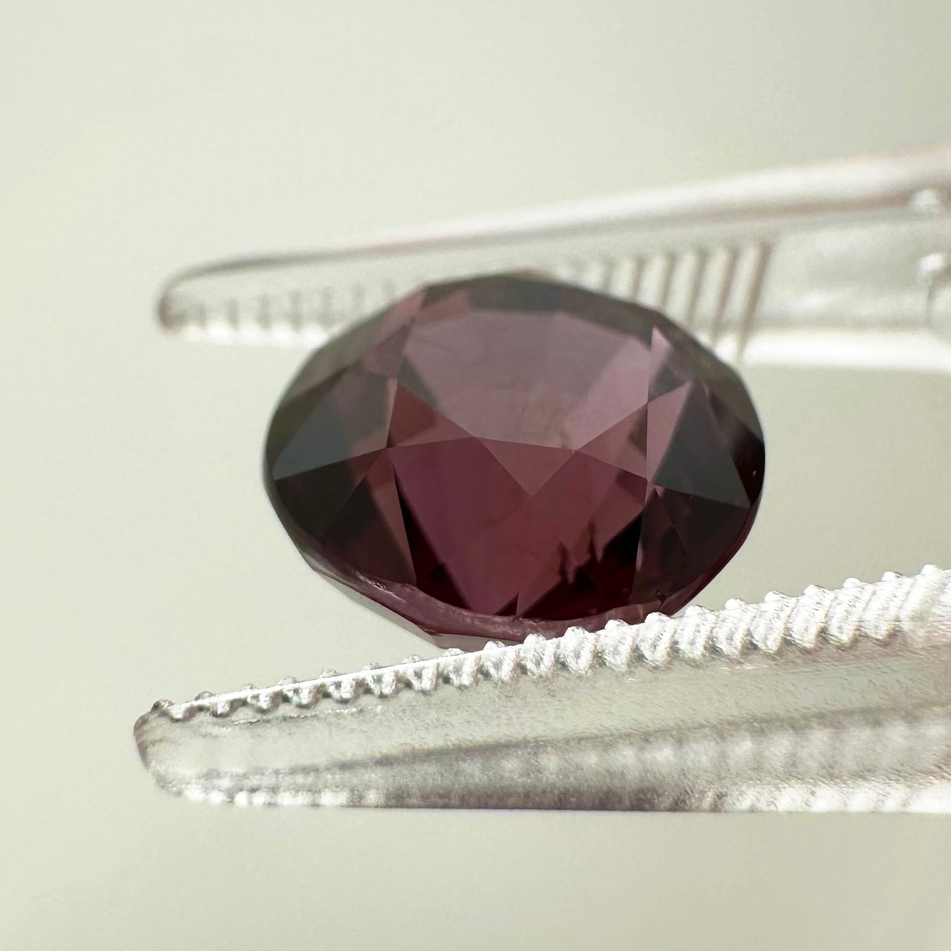 Side profile view of the unheated 3.20 carat Vietnam deep pink spinel highlighting its perfect symmetry and pavilion depth.