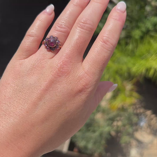 antique victorian daisy ring worn at natural light, full of garnet, more than 100 years