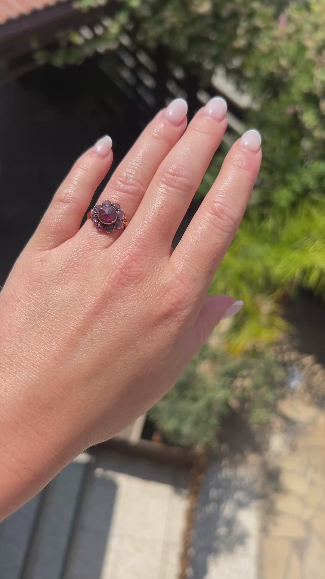 antique victorian daisy ring worn at natural light, full of garnet, more than 100 years